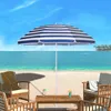 A beach scene with chairs, a table, and a striped umbrella. Produktbild-Vorschau