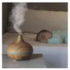 A baby sleeping next to an aroma diffuser on a nightstand. Podgląd zdjęcia produktu