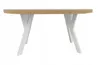 A studio shot of a round dining table with a light wood top and white criss-cross legs, presented against a white background. Náhled obrázku produktu