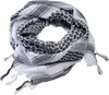 A folded black and white patterned scarf with tassels. Produktbild-Vorschau