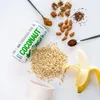 A can of Coconaut coconut water is shown with ingredients like oats, almonds, walnuts, flax seeds, cocoa powder, and a banana. Produktbild-Vorschau