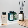 Several bottles of diffuser fragrance and reed diffuser sticks are arranged on a light-colored surface, with a woven mat in the foreground. Podgląd zdjęcia produktu