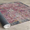 A rolled-up rug is shown on a wooden floor. Produktbild-Vorschau