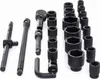A set of black metal socket wrenches and accessories laid out on a white background. Produktbild-Vorschau