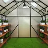 Interior view of a greenhouse with plants on shelves and artificial grass on the floor. Produktbild-Vorschau