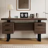 A modern wooden desk with black metal legs, set against a white wall with artwork above. The desk has drawers and a spacious top. Podgląd zdjęcia produktu