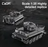 Two detailed model tanks are displayed on a dark, textured surface with a blurred background suggesting a battlefield or industrial setting. Náhľad obrázku produktu