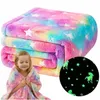 A folded blanket with a rainbow and star pattern, and a young girl wrapped in a similar blanket. Náhľad obrázku produktu