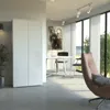 A modern office or living space with a white cabinet, a desk with chairs, and a comfortable armchair. Produktbild-Vorschau