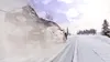 A rally car driving on a snowy road, kicking up snow. Produktbild-Vorschau