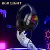 A gaming headset with RGB lighting is held by a robotic hand, with gaming controllers and speakers in the background. Produktbild-Vorschau