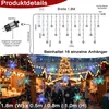 A festive outdoor market scene at night, decorated with snowflake string lights. Produktbild-Vorschau