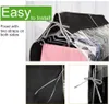 Close-up shots of a black fabric garment bag for clothes on hangers, highlighting the tie straps for installation. Produktbild-Vorschau