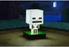 A Minecraft Skeleton lamp is displayed on a wooden surface with a dark, blurred background. Náhled obrázku produktu