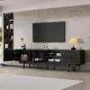 A modern black TV stand with a TV mounted above it, in a living room setting. Produktbild-Vorschau
