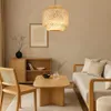 A cozy living room scene with a bamboo pendant light, a wooden cabinet, a coffee table, and a sofa. Náhled obrázku produktu