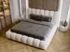 A bedroom scene with a large bed as the focal point. Produktbild-Vorschau