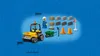 A collection of LEGO construction toys, including a yellow front loader, a green wheelbarrow, construction cones, building blocks, and a LEGO minifigure, set against a blue brick wall background. Produktbild-Vorschau