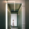 A person walks down a hallway with modern lighting. Náhľad obrázku produktu