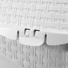 A close-up view of the white plastic woven texture and latch mechanism of a pet carrier. Produktbild-Vorschau