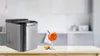 An ice maker and a cocktail are displayed on a kitchen counter. Náhled obrázku produktu