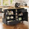 A black kitchen island cart with a wooden top, filled with various kitchen items and appliances, is shown in a kitchen setting. Produktbild-Vorschau
