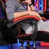 A person sitting in a gaming chair, with a computer setup in the background. Náhled obrázku produktu