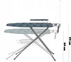 An ironing board with a wire rack underneath, shown in a side profile with ghosted images indicating adjustable height. Produktbild-Vorschau
