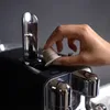 A hand is inserting a coffee capsule into a coffee machine. Produktbild-Vorschau
