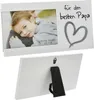 A white photo frame with a picture of a father and son, and text and a heart graphic. Produktbild-Vorschau