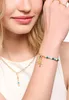 Close-up of a woman's arm and neck, showcasing jewelry. Náhled obrázku produktu
