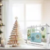 A retro-style blue Bluetooth speaker is displayed next to a decorative paper Christmas tree and a lit candle on a white surface, with a blurred window in the background. Produktbild-Vorschau