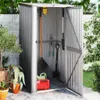 An open garden shed filled with gardening tools and a red watering can. Produktbild-Vorschau