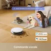 A woman and her dog are in a living room, with a robot vacuum cleaner cleaning the floor. Produktbild-Vorschau