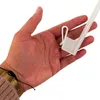A hand holding a white plastic Christmas tree star ornament for a car. Podgląd zdjęcia produktu
