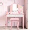 A pink children's vanity table with a tri-fold mirror and a matching stool, decorated with Hello Kitty stickers. Podgląd zdjęcia produktu