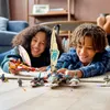 Two children playing with LEGO Ninjago catamaran building sets on the floor. Voir les images du produit
