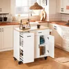 A white kitchen island with a wooden countertop is shown in a kitchen setting. Produktbild-Vorschau