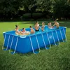 A family is enjoying a rectangular above-ground swimming pool in a grassy backyard. Anteprima dell’immagine prodotto