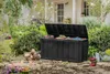 A black Keter Sherwood garden box is open and filled with various garden tools and supplies, placed in a garden setting with a house in the background. Anteprima dell’immagine prodotto