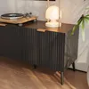 A close-up shot of a modern media console with a turntable and a lamp on top. Podgląd zdjęcia produktu