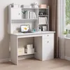A white computer desk with shelves and drawers, set up in a room with a window and curtains. Podgląd zdjęcia produktu