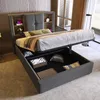 A grey upholstered bed with a headboard featuring storage shelves, shown with the storage compartment open to reveal stored items. Náhľad obrázku produktu