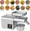 An automatic oil press machine made of stainless steel, shown with various seeds and nuts that can be processed. Náhled obrázku produktu