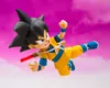 A Son Goku action figure in a dynamic pose against a pink, cloudy sky. Produktbild-Vorschau
