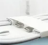 Close-up of two USB-C connectors of a white charging cable, partially inserted into a white paper holder. The background is blurred and shows the word 'iPhone'. Produktbild-Vorschau
