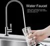 A hand is filling a glass with water from a faucet. Produktbild-Vorschau