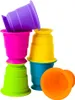 A group of colorful stacking cups arranged in a playful manner against a white background. Voir les images du produit