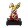 A colorful figurine of a rabbit sitting on a black base. Produktbild-Vorschau