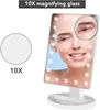 A woman applying makeup using a lighted cosmetic mirror with a 10x magnification feature. Produktbild-Vorschau